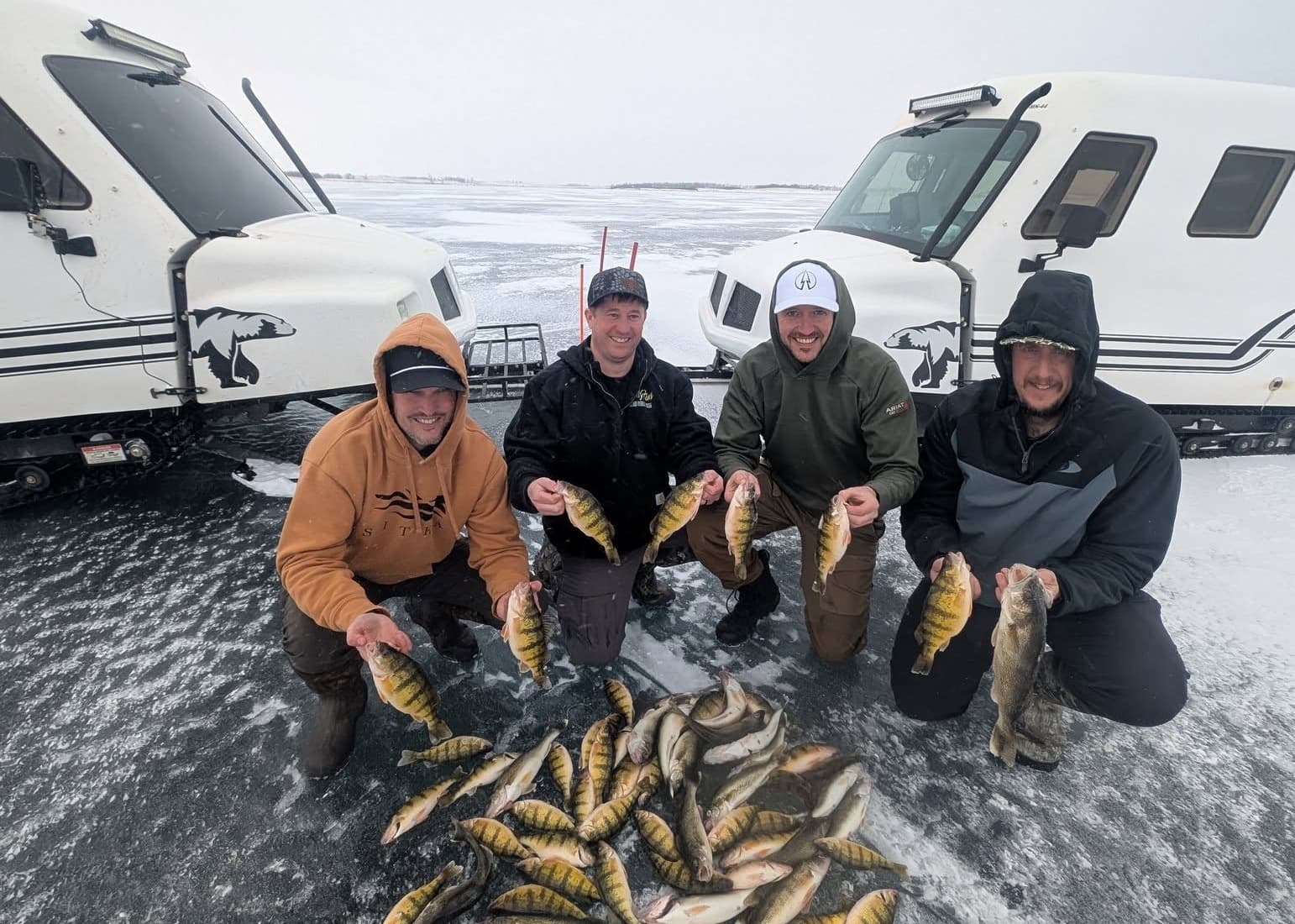 Guests holding their catch inside an Only Fins ice shack